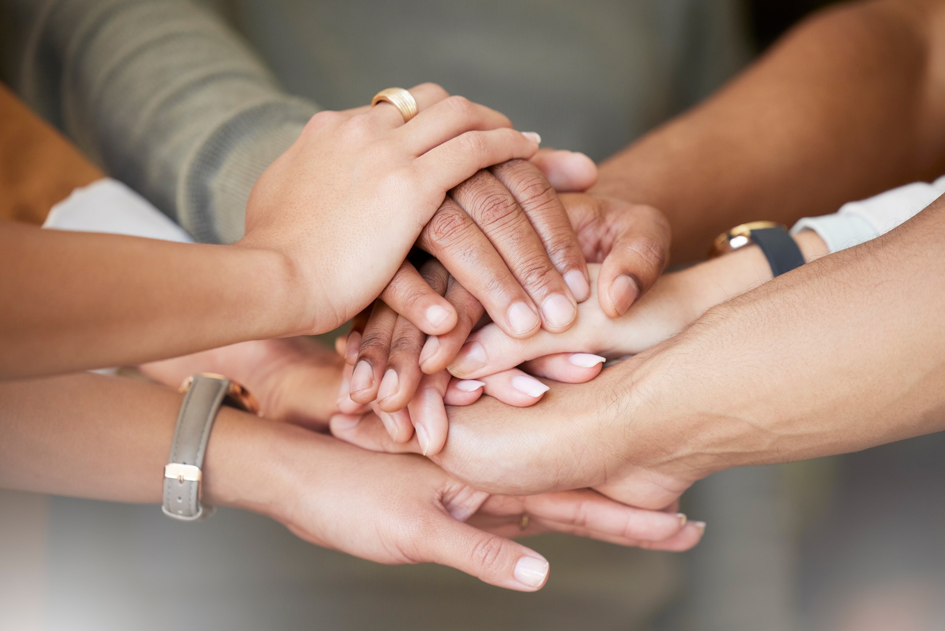 Office, teamwork and hands in huddle together for team building, collaboration and motivation at startup company. Work, goals and diversity, employees with business growth, development and support.